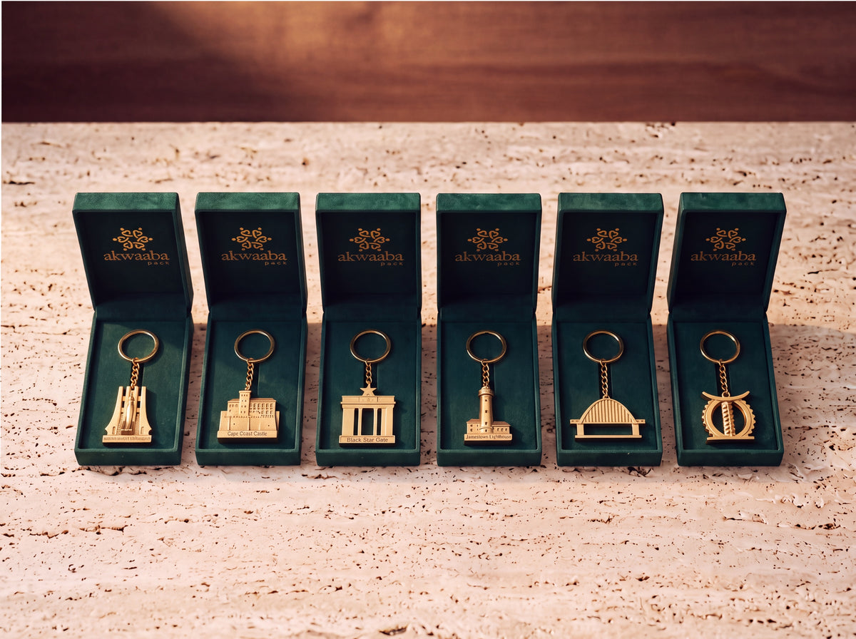 Six Ghanaian landmark keychains in green velvet House of Akwaaba boxes